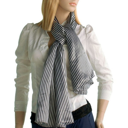 Black and white striped scarf worn with tied bow, fringed ends