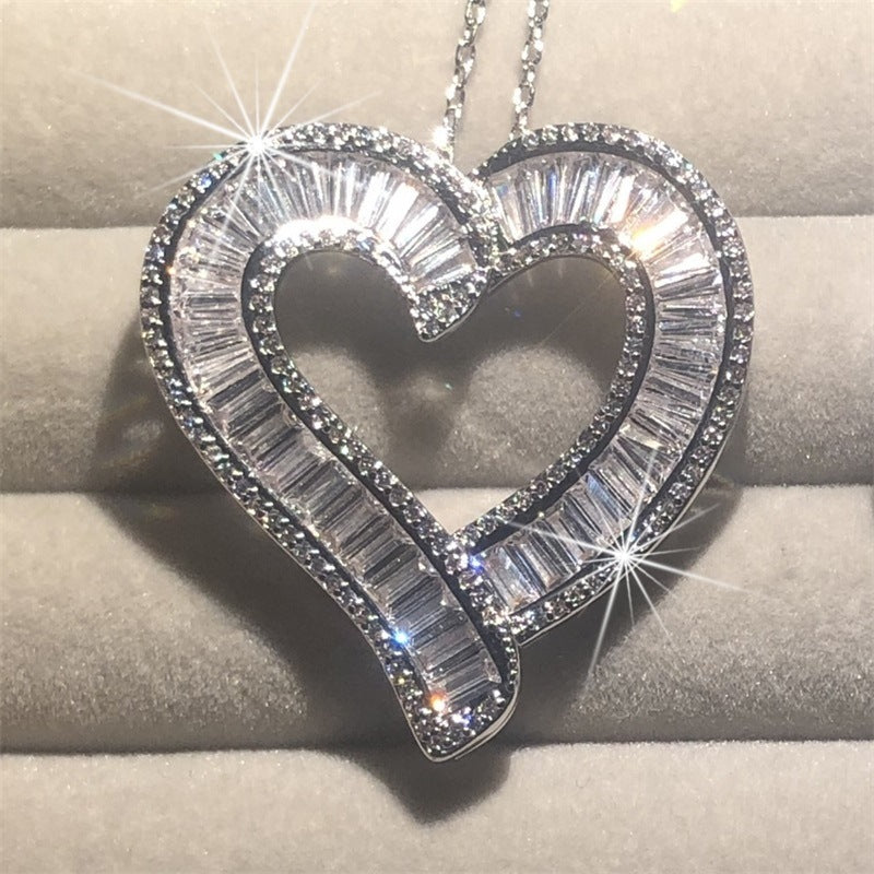 Heart pendant necklace featuring a silver-tone double halo faux diamond heart design