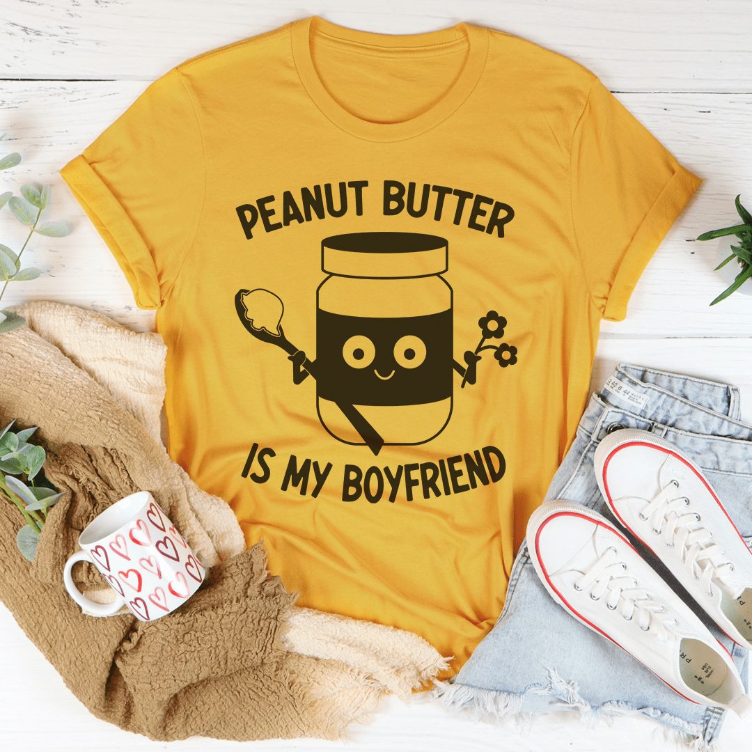 Mustard yellow unisex T-shirt with “PEANUT BUTTER IS MY BOYFRIEND” graphic front