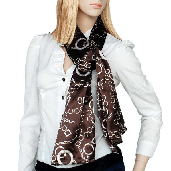 Black and brown printed silk neck scarf with chain-link pattern, worn by model