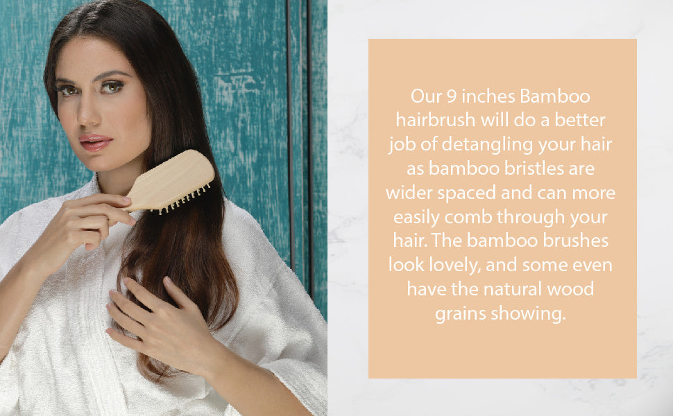 Natural wooden detangling hair brush in use, held near long dark hair