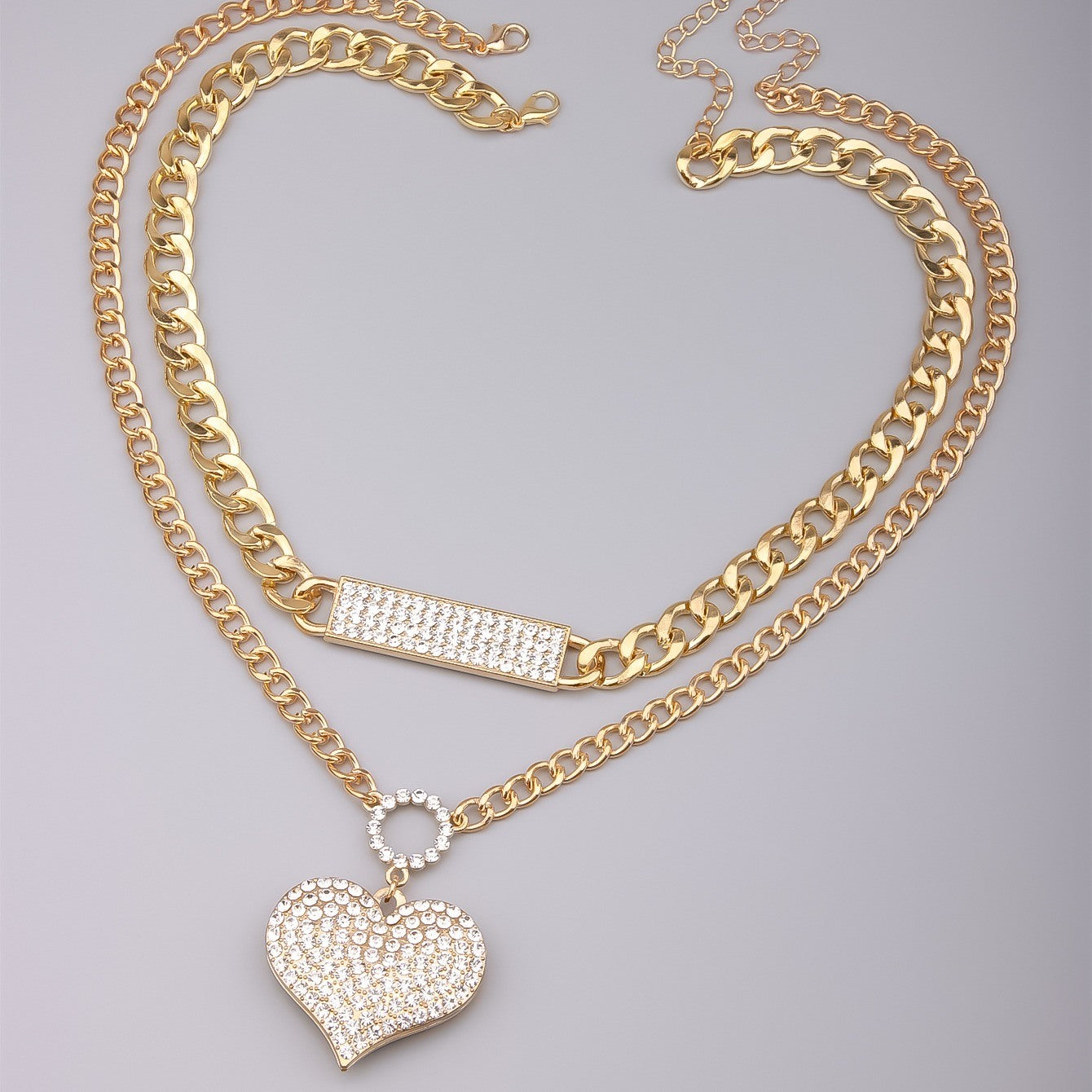 Gold double-layer necklace set with crystal bar and heart pendant on curb chains