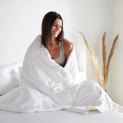 White duvet comforter draped over a person, quilted channel design