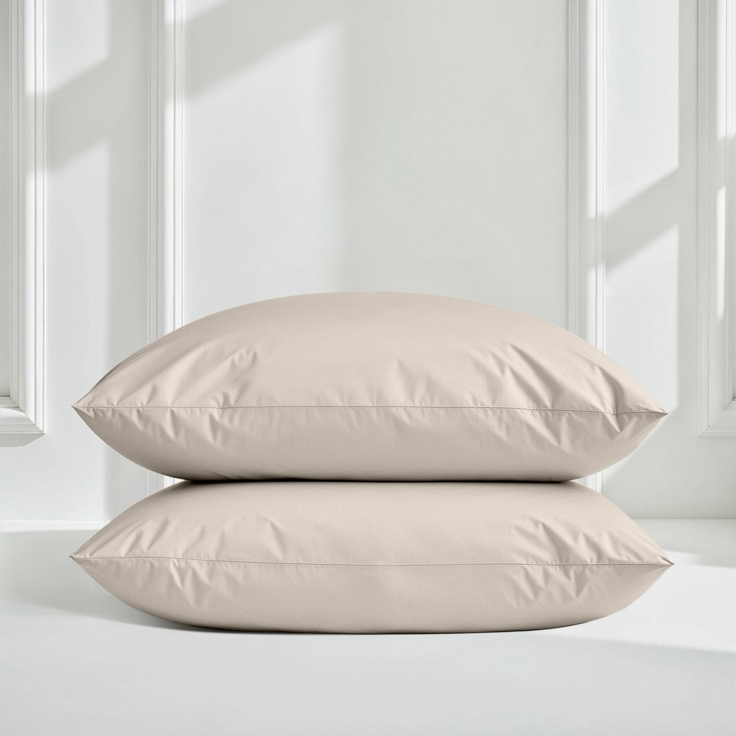 Sateen bedding bundle with two light beige pillows, stacked with smooth seams