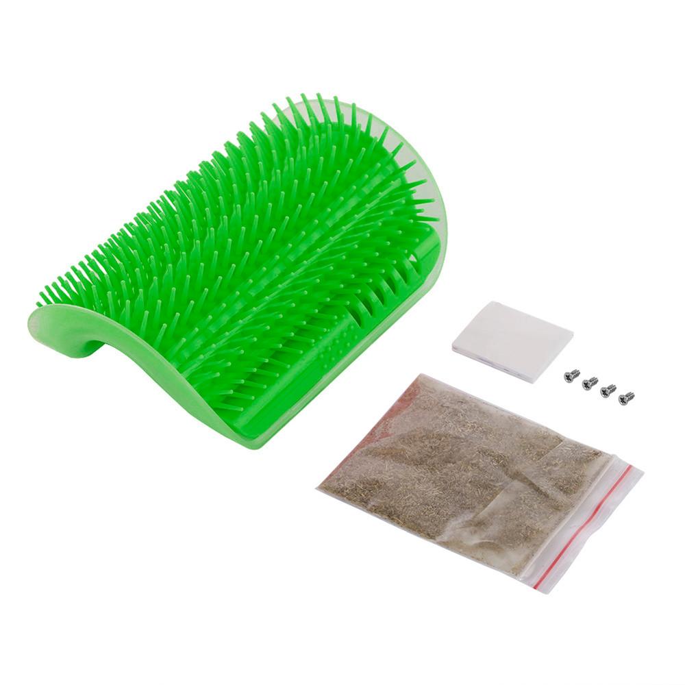 Green pet corner brush with bristles, plus small accessory items and mounting pieces.