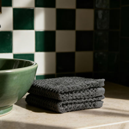 Charcoal waffle hand towels stacked with visible waffle weave detail