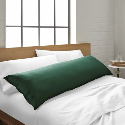Bamboo body pillowcase in emerald green, on a bed with a white sheet