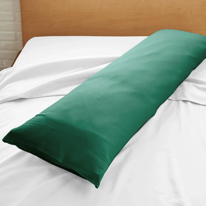 Bamboo body pillowcase in deep green, folded on a white bed sheet