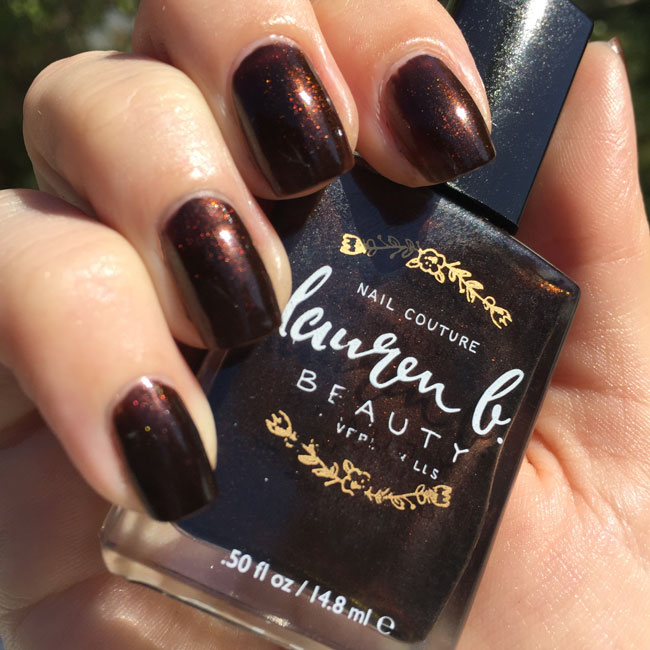 Manicured fingernails with dark espresso brown glossy, shimmery shine