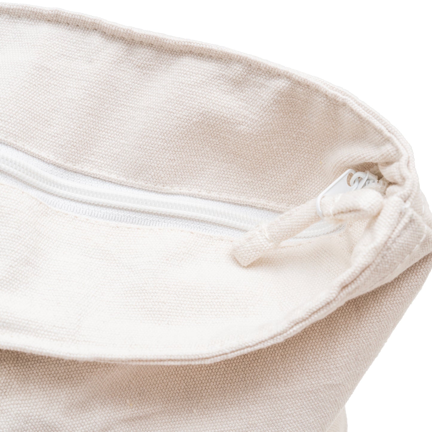 Off-white canvas tote zipper opening with folded top edge and draw cord.