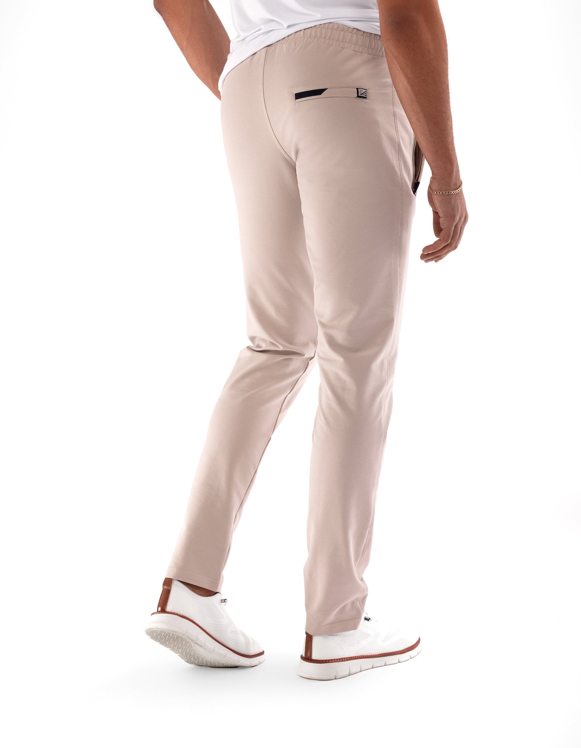 Athletic sweatpants with tapered legs and elastic waistband; light khaki finish.
