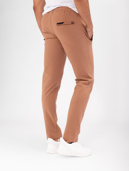 Rust brown tapered athletic sweatpants with elastic waistband and side pocket