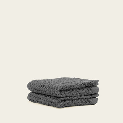 Charcoal waffle towels stacked flat, showing textured weave
