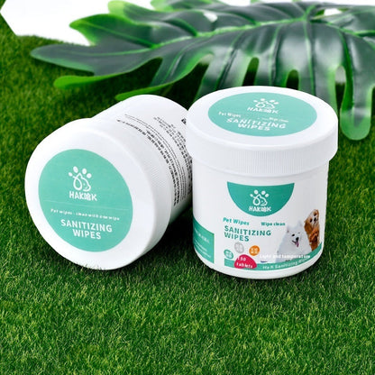 Pet sanitizing wipe canister and lid on green grass, teal SANITIZING WIPES label