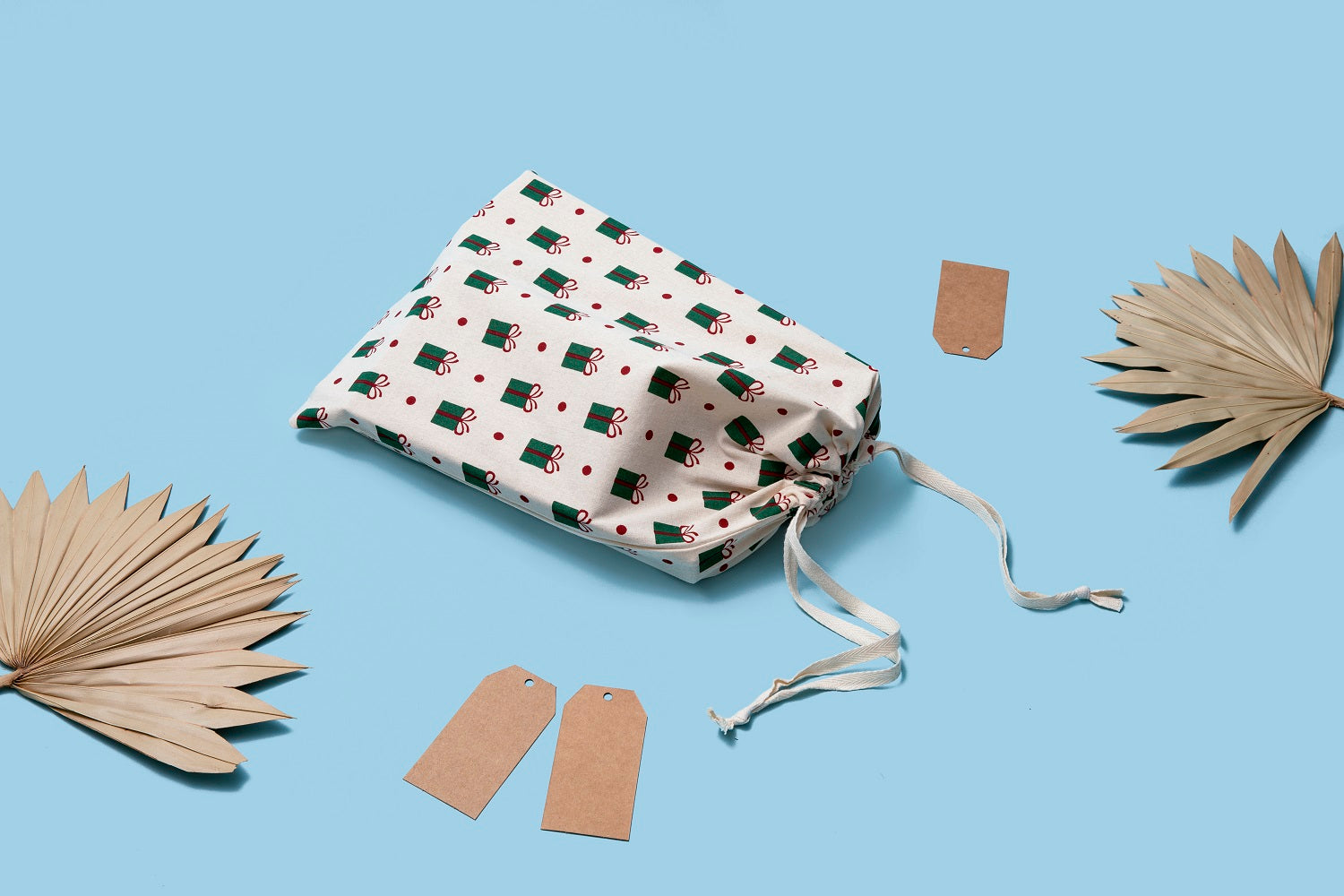 White cloth gift bag set with holly gift-print pattern, drawstring top