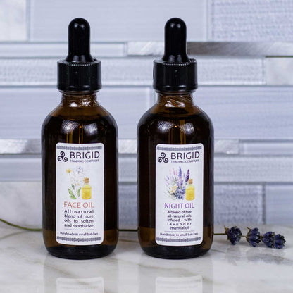 BRIGID face oil bottles with black droppers, amber glass, white label