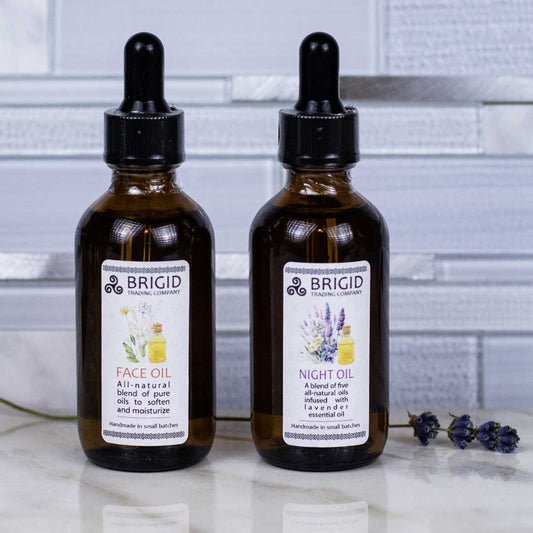 BRIGID face oil bottles with black droppers, amber glass, white label