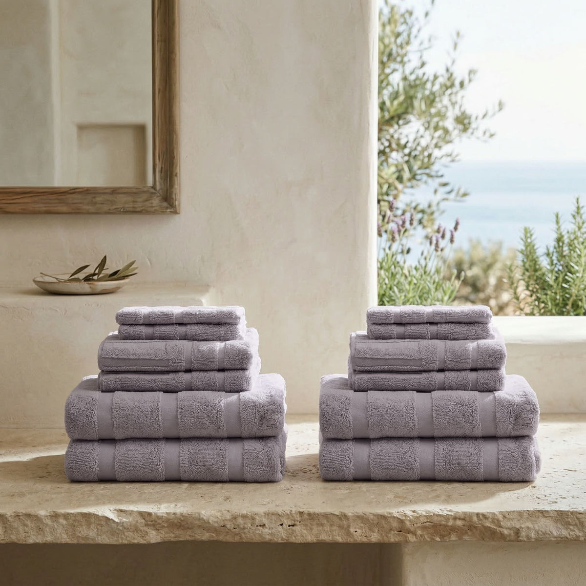 Lilac cotton towels stacked, with folded hand and bath towels