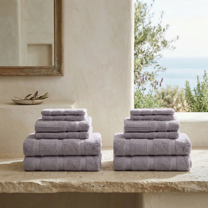 Lilac cotton towels stacked, with folded hand and bath towels