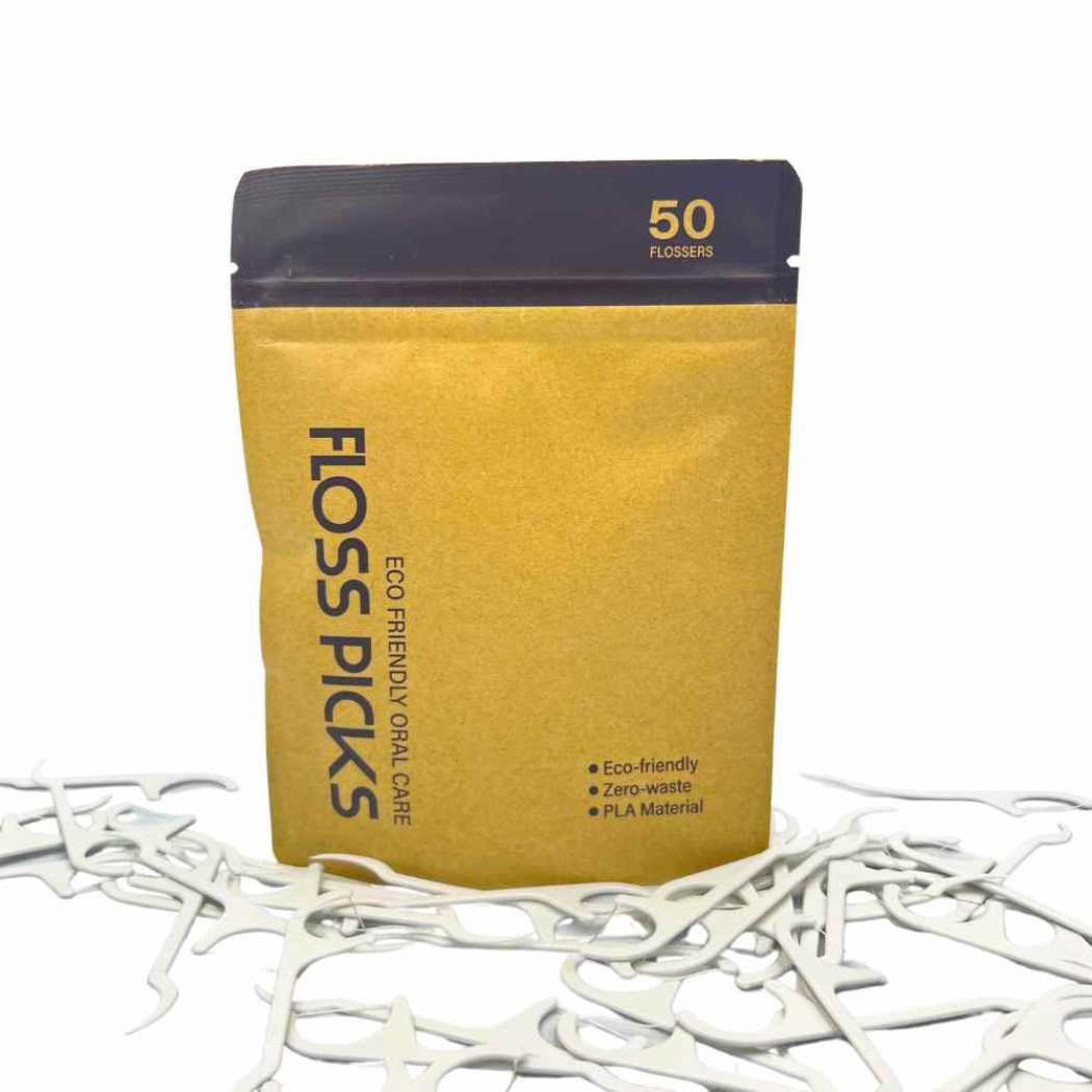 Floss picks pouch with 50 flossers, white picks scattered on a white surface