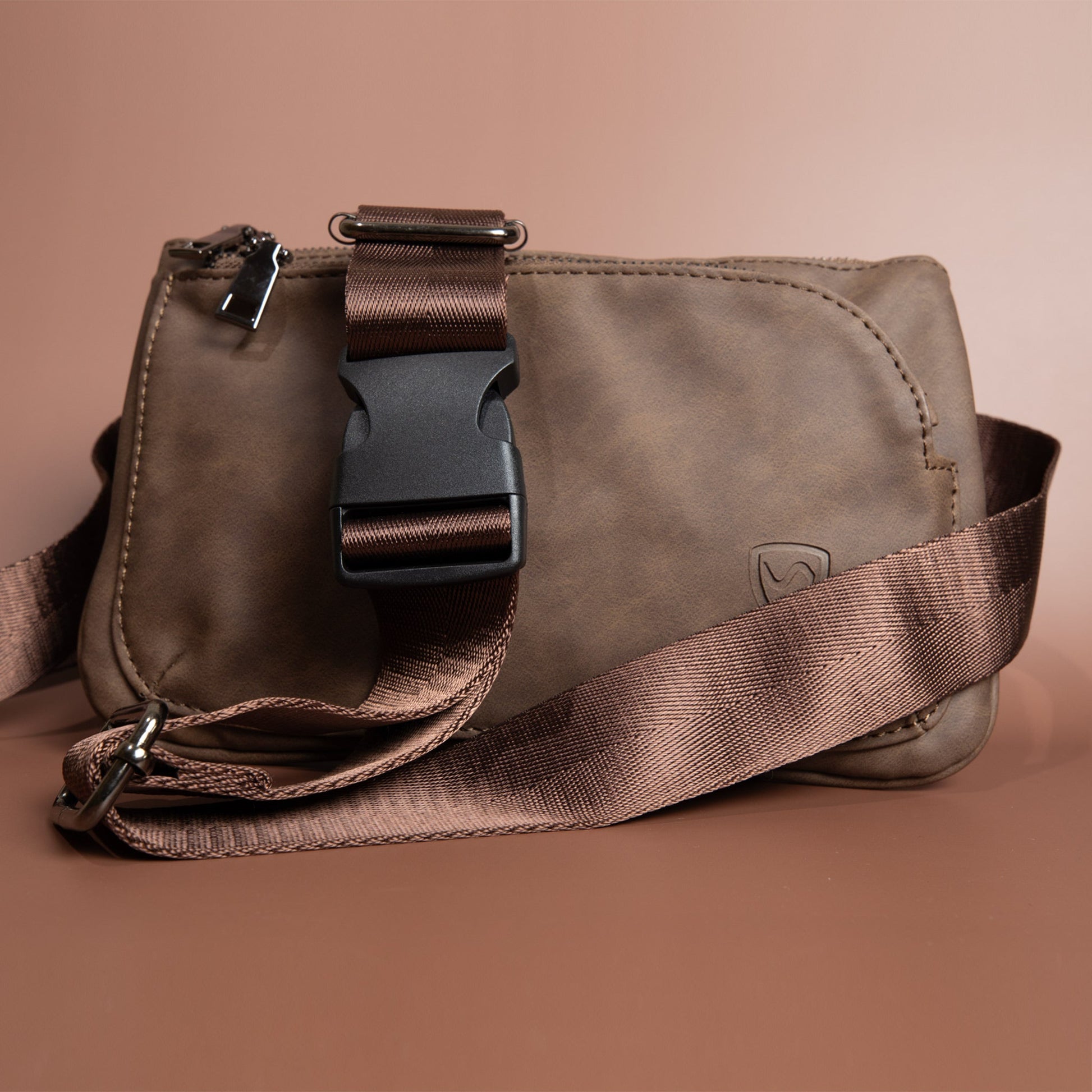 Vegan leather crossbody fanny pack with adjustable strap and metal buckle hardware