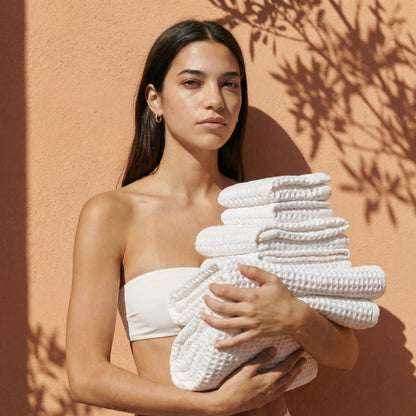 White waffle cotton towels, neatly folded stack with textured grid weave