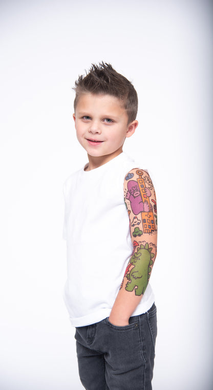 Temporary kids tattoo sleeve on boy’s arm with dinosaur and city icons