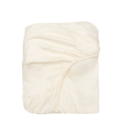 Organic sateen fitted sheet in natural cotton, folded flat with smooth surface