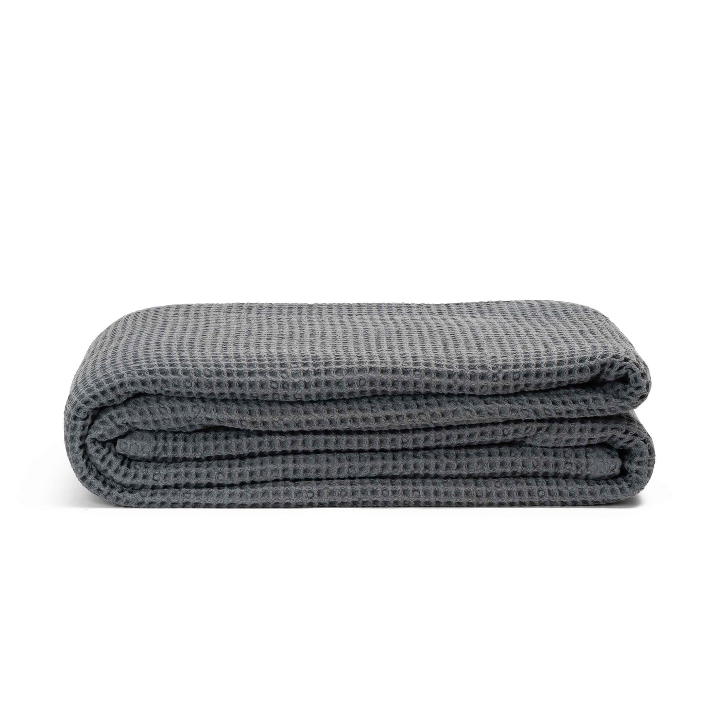 Gray waffle weave throw blanket, folded into a neat stack.