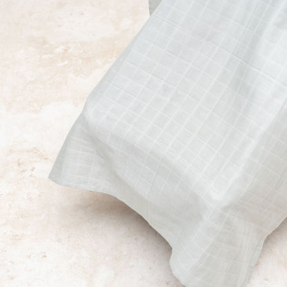 Muslin car seat cover in gray with flowing drape and textured weave