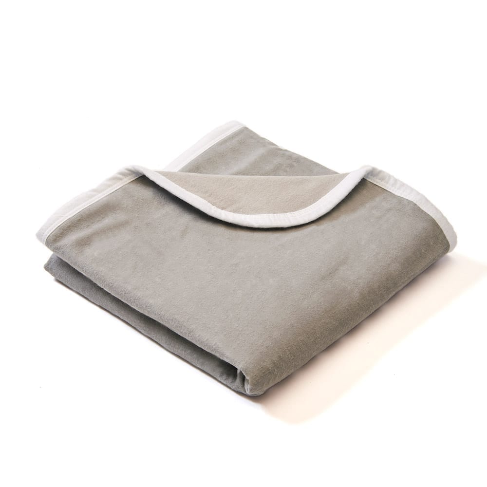 Light gray baby blanket folded with white trim along the edges