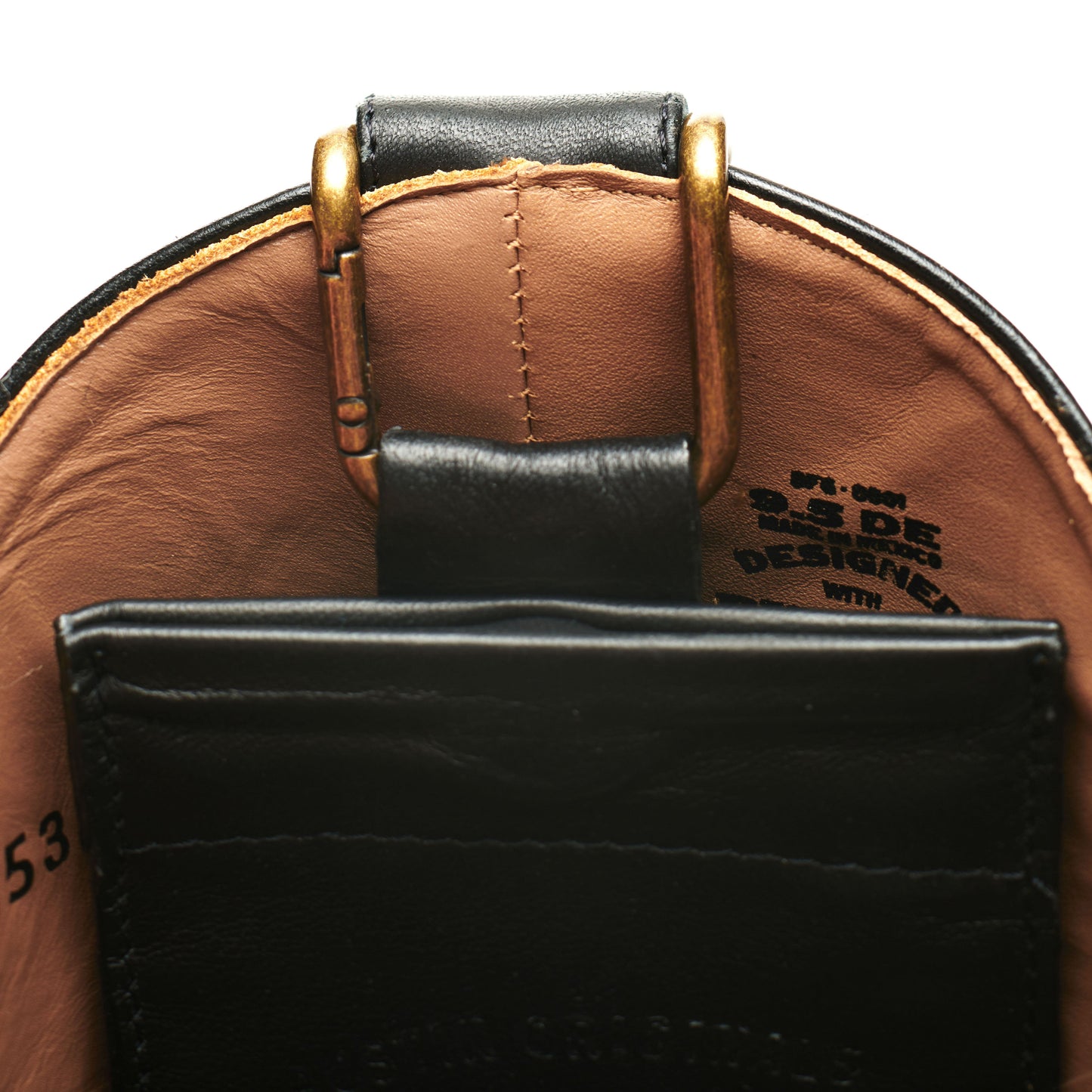 Black leather boot mule with brass buckle; front pocket and logo on lining
