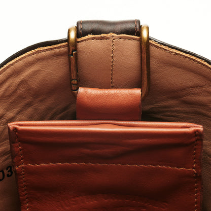 Brown leather boot mule with brass buckle; front pocket holds cash