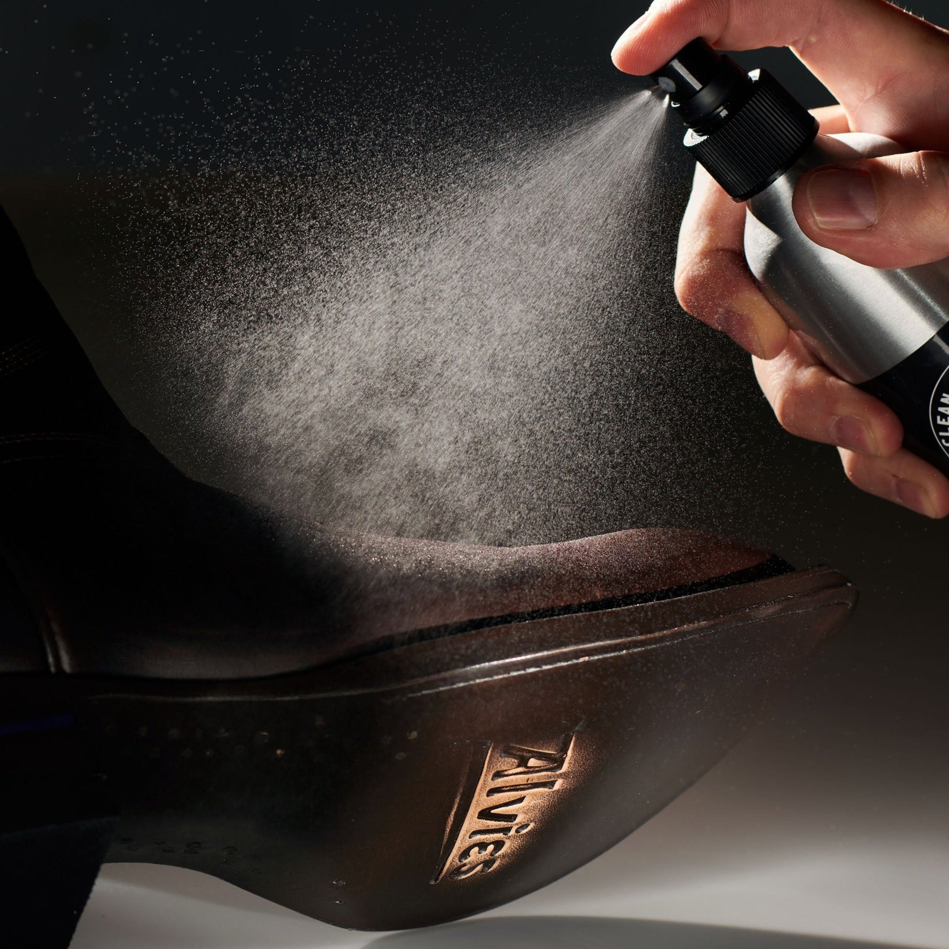 Leather conditioner misting dark leather boot toe