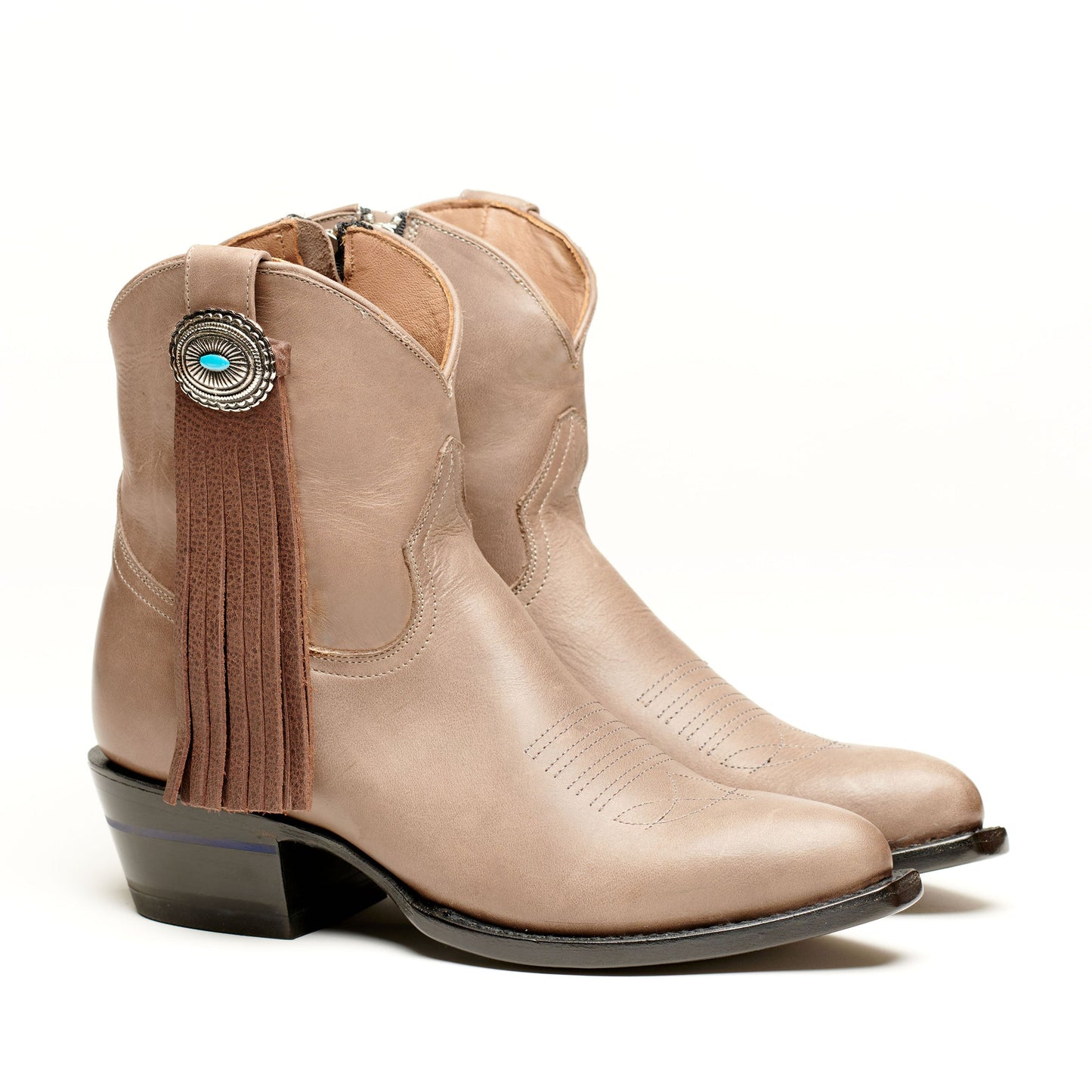 Tan boot with long fringe tassel and turquoise-accent concho