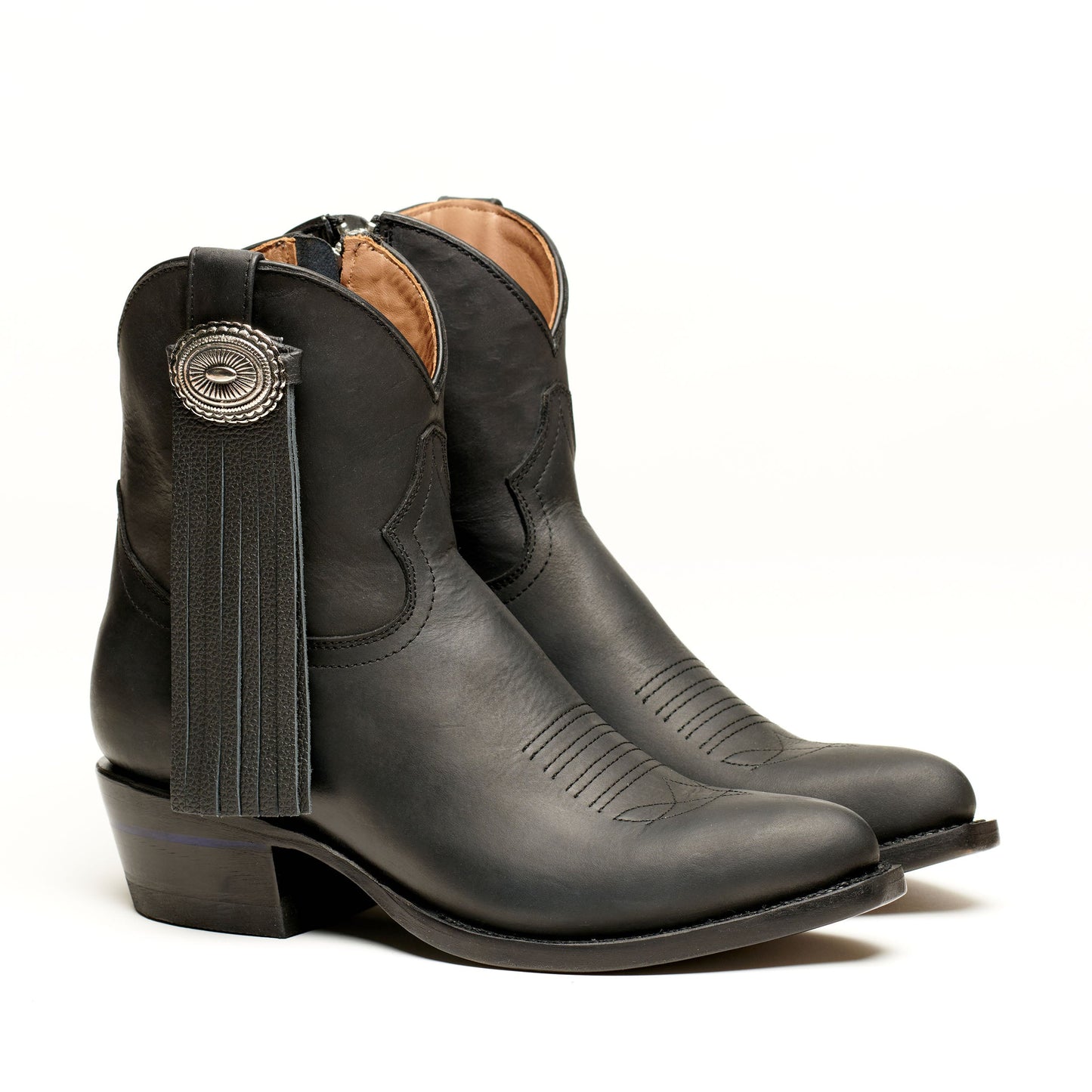Dark leather western boot with long tassel detail and round concho at side