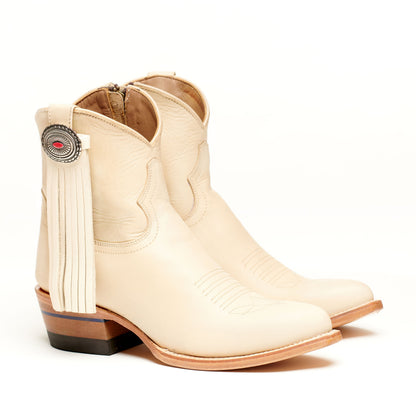 Light tan leather western boot with long tassel fringe and round concho accent