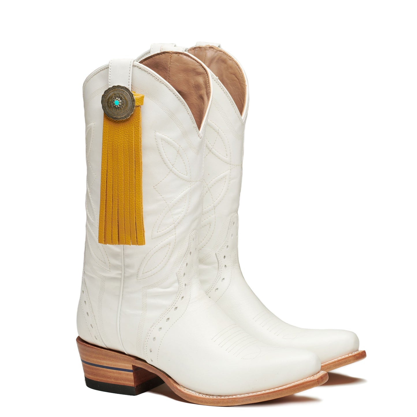 White cowboy boot with quilted panels and yellow fringe tassel with concho