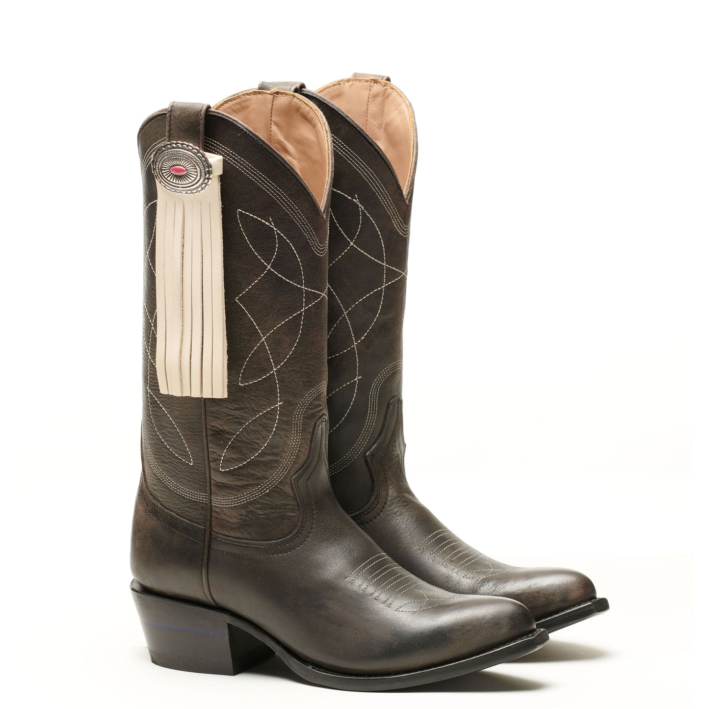 Dark brown leather western boot with long tassel fringe and round concho badge