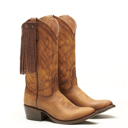 Tan cowboy boots with long fringe on the shaft and quilted side panel