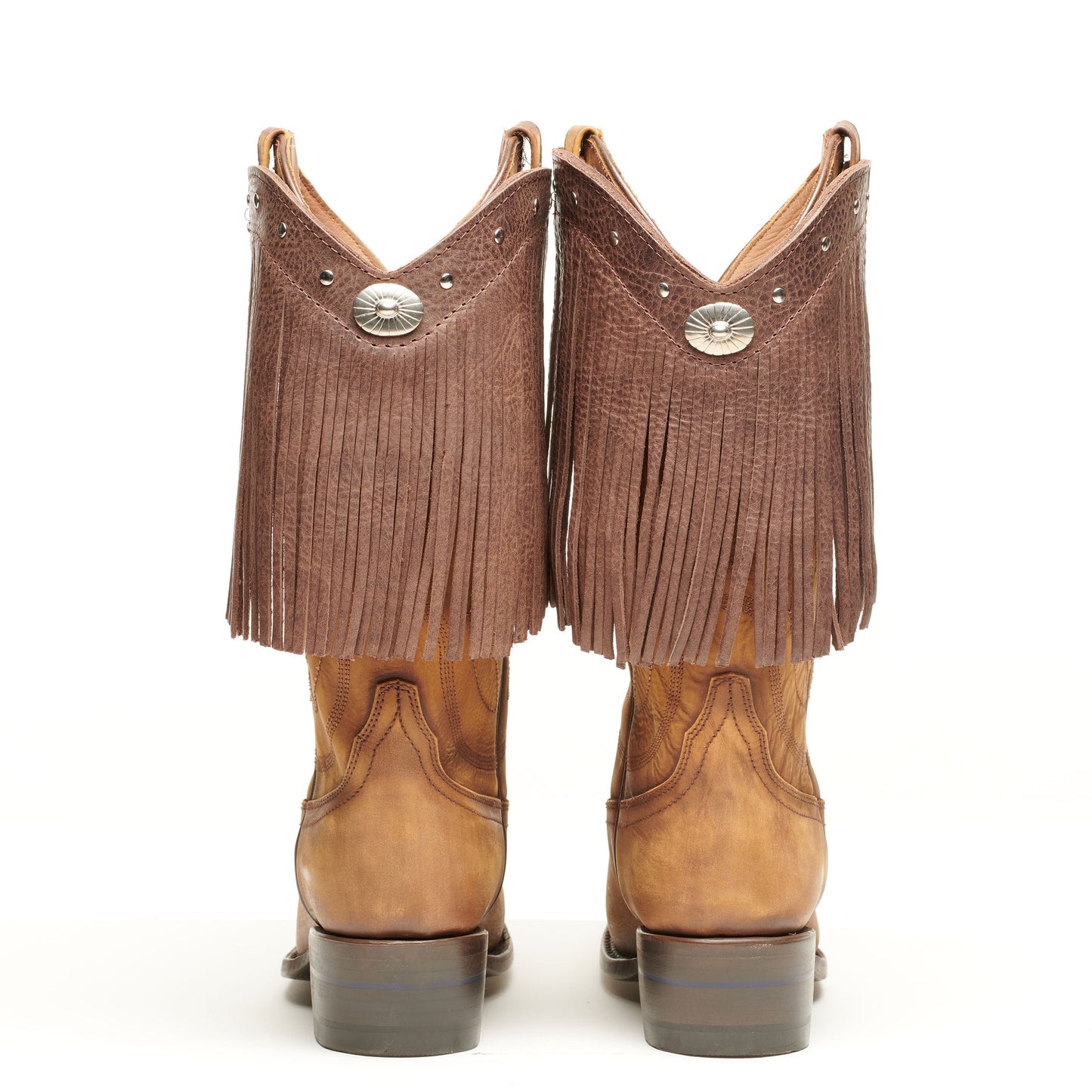 Pair of brown fringe cowboy boots from the back with concho and stud accents