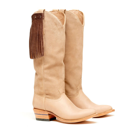 Light tan tall cowboy boots with long fringe on side and block heel
