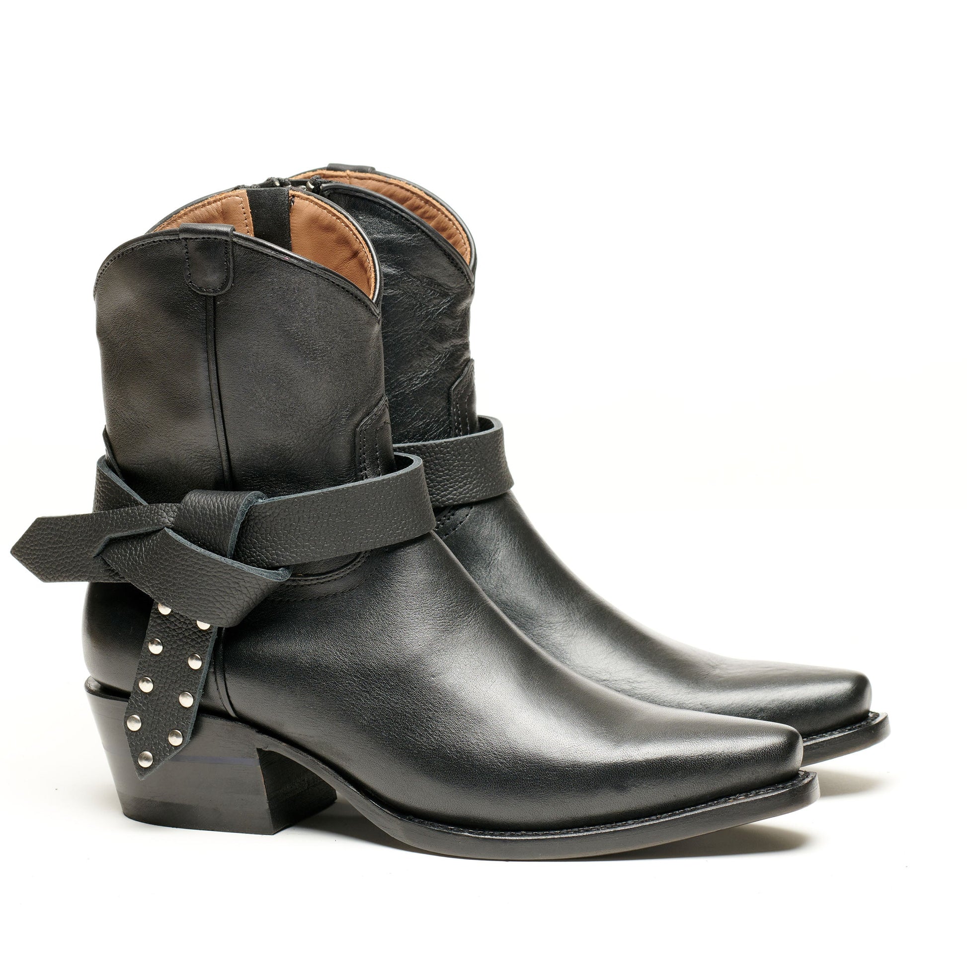 Black mid-calf boot with wrapped strap, buckle, and tan lining