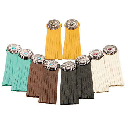 Assorted boot tassels in yellow, turquoise, brown, gray, and cream with concho tops