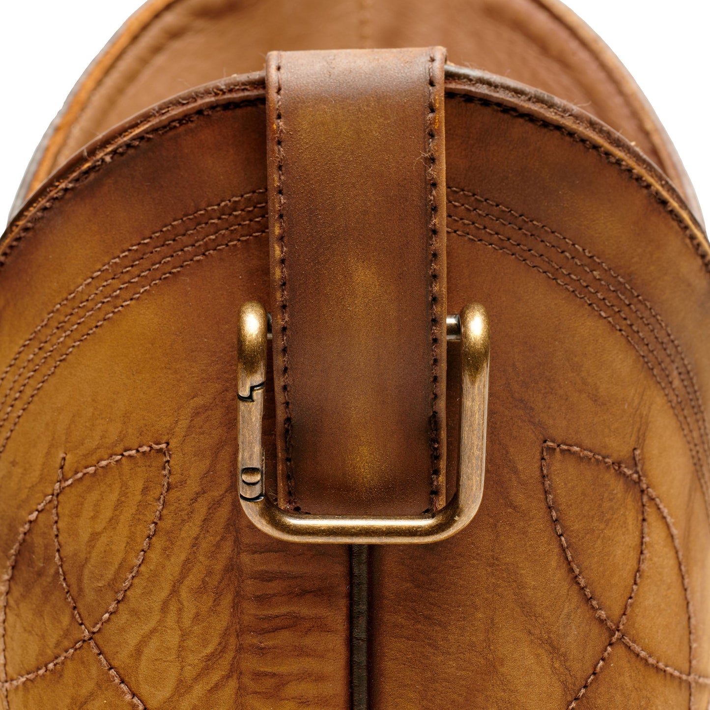 Boot pull clip with gold U-frame on tan leather backing and stitching detail.