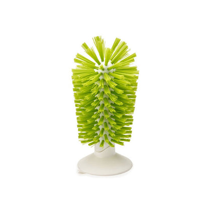 Standing bottle brush with bright green bristles on white base