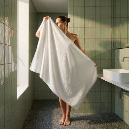 White cotton bath towel, plush terry texture, draped around body