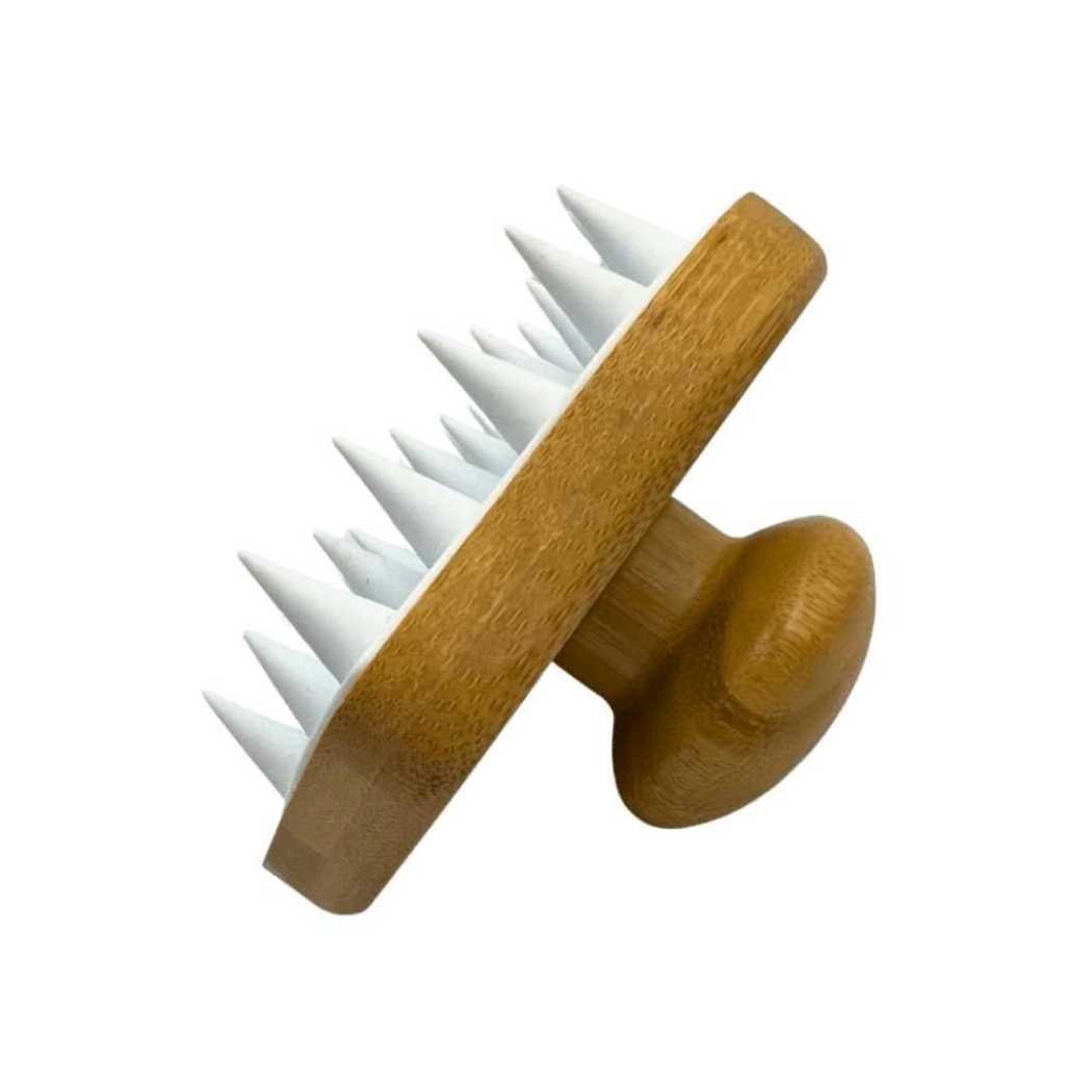 Hair and scalp massaging brush with angled wooden face and white nubs