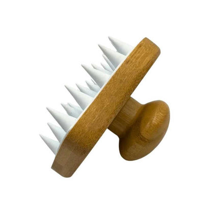 Hair and scalp massaging brush with angled wooden face and white nubs