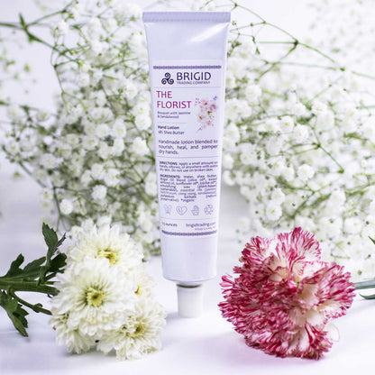 Natural hand lotion tube, white with purple top; BRIGID label on front
